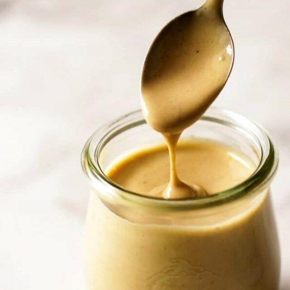 1584626051.Tahini-Dressing-Dripping-from-a-Spoon-into-a-Jar-640×960